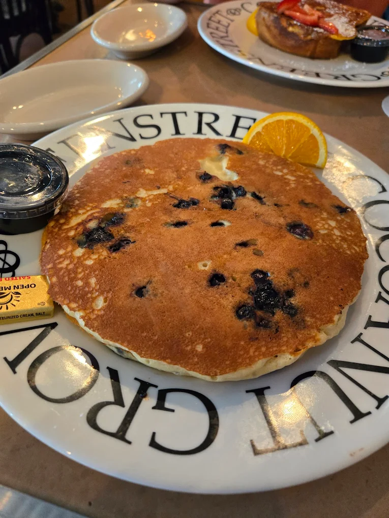 Blueberry pancakes on a branded Greenstreet Coconut Grove plate, one of the best brunch spots in Coconut Grove